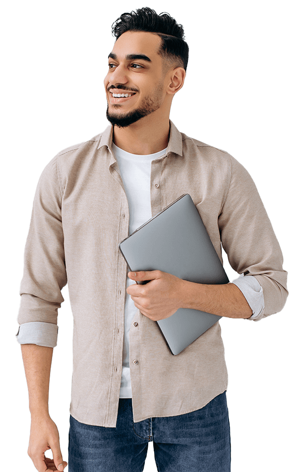 Man smiling while holding a laptop